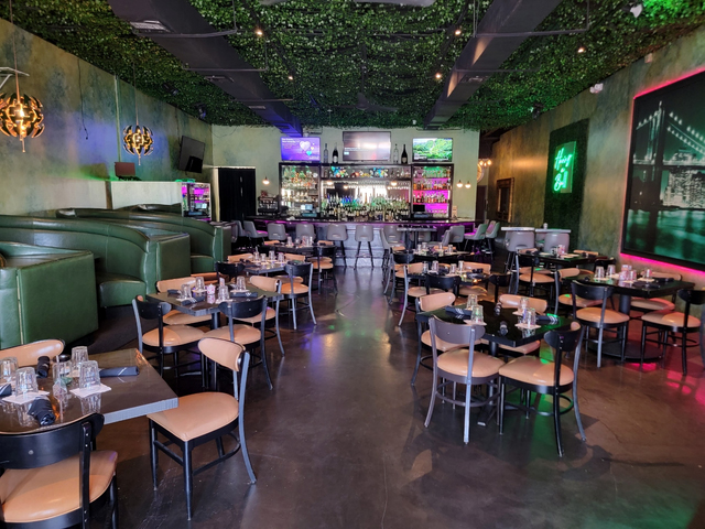 Restaurant interior space with tables and colorful lighting